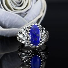 This stunning 925 sterling silver handcrafted filigree art angel wings design cocktail ring with gemstone is the perfect gift for any special occasion. The intricate filigree design is made with high-quality materials and features a beautiful gemstone of your choice (lapis lazuli, rose quartz, or labradorite). The angel wings design is elegant and timeless, making this ring a perfect choice for any woman. The ring is made with 925 sterling silver and features a 7x14 mm cabochon oval cut gemstone. The gemstone is natural and comes in your choice of lapis lazuli, rose quartz, or labradorite. The ring also comes with a silver polish cloth and a luxurious gift box. This ring is perfect for anniversaries, birthdays, Thanksgiving, Christmas, Mother's Day, or any other special occasion. It is als Metal Embroidery, Angel Wings Design, Art Angel, Bold Rings, Filigree Jewelry, Sterling Silver Filigree, Filigree Design, Filigree Ring, Silver Filigree