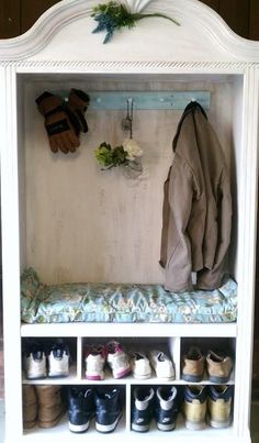 a white shelf filled with lots of shoes