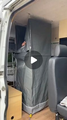 the inside of a van with an open door and seat covers on it's side