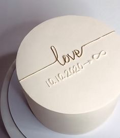 a white cake with the word love written on it