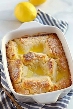 a lemon cobbler in a white dish on a blue and white towel