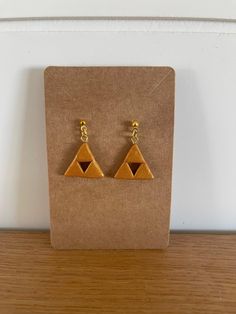 the earrings are made out of wood and have two triangles on each earwires