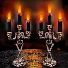 skeleton candlesticks with burning flames on them