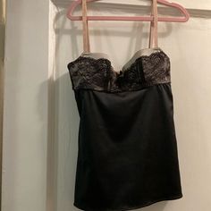 This Is A Stunning Dolce & Gabbana, Lace And Satin/Elastin Bustier Camisole. It Is Piped With Gross Grain Ribbon It Has A Built-In Bra Only For An Extra Small Individual. It Has A Gross Grain. Tiny Flat Bow With The D & G Gold Plate Insignia.Tthe Straps Are Nude Colored, And Have Gabbana Embroidered Into Them. The Back Has An Adjustable Three Hook Bra The Bra Is Silver With Black Lace Overlay. The Bodice Is Black Satin/Elastin Mint Condition. Delicate Strap Sleeveless Tank Top For Evening, Evening Tank Top With Delicate Straps, Sleeveless Tank Top With Delicate Straps For Evening, Silk Fitted Tank Top For Evening, Evening Lace Top Camisole, Party Camisole With Boned Bodice, Fitted Evening Tank Top With Delicate Straps, Evening Lace Trim Camisole Tank Top, Fitted Tank Top With Delicate Straps For Evening