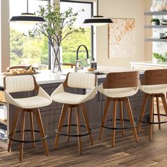 three stools in front of a kitchen island