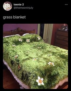 a bed covered in green grass with daisies on it's side and the words grass blanket written below