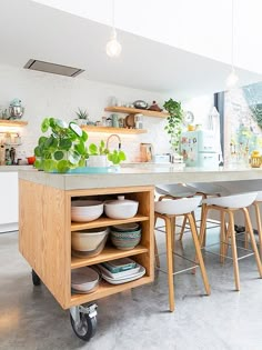 a kitchen island with plates and bowls on it