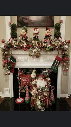 a mantel decorated with christmas decorations and santa clause on it's mantle in front of a fireplace