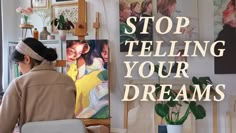 a woman sitting in front of a painting with the words stop telling your dreams