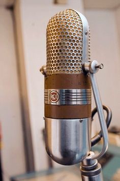 an old fashioned microphone sitting on top of a table