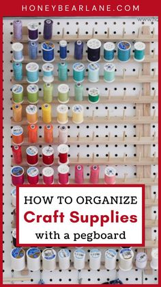 an organized craft supply rack with pegboards and spools filled with colorful thread