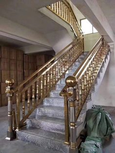 there is a gold railing on the stairs