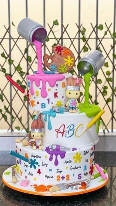 a three tiered cake decorated with cartoon characters