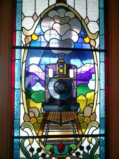 a stained glass window with a train on it