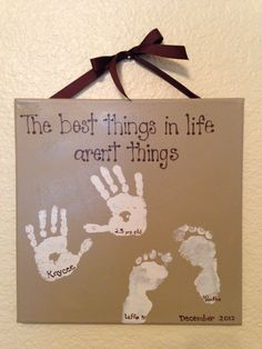 a sign that says the best things in life aren't things with two handprints on it