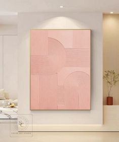 a pink painting hanging on the wall in a living room