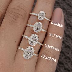 three different sizes of engagement rings on someone's hand with measurements for each ring