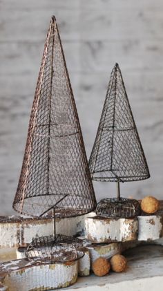 two metal sailboats sitting on top of a white cabinet