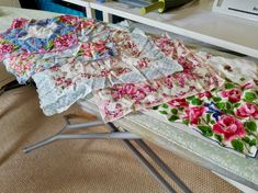 an ironing board covered in fabric and flowers