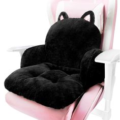 a chair with a black cat pillow on it's back and pink seat cushion