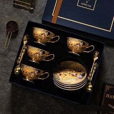 a set of golden dishes in a black box