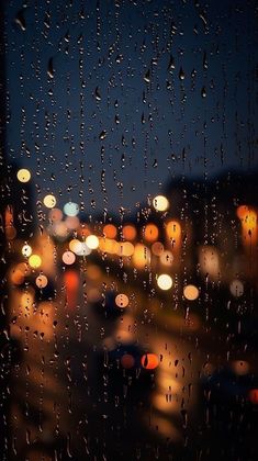 rain drops on the window at night time