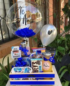 a wooden crate filled with snacks and balloons