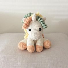 a crocheted stuffed animal sitting on top of a bed