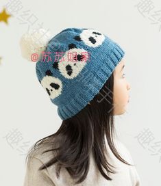 a doll wearing a blue hat with panda bears on it