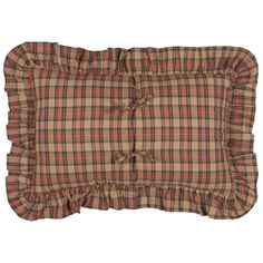 a brown and red plaid pillow with ruffles on the front, sitting on a white