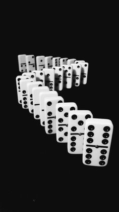 several white dices are lined up in the shape of a number on a black background