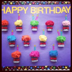 cupcakes with candles are arranged on a birthday card