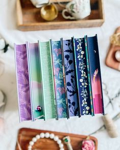 a bunch of books that are on top of a wooden tray next to other items