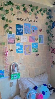 a child's bedroom with posters and stuffed animals on the wall