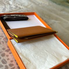 an orange box with two wallets in it