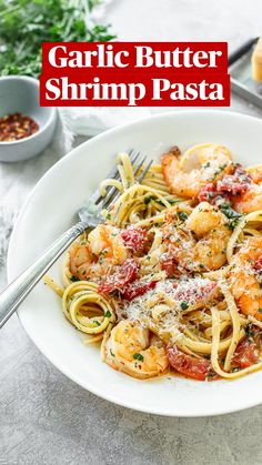 a pasta dish with chicken, tomatoes and onions on a blue and white striped plate