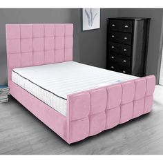 a pink bed frame with no sheets on it in a room next to a dresser and drawers