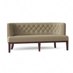 a beige couch sitting on top of a wooden frame