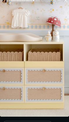 a yellow dresser with baskets on it and a mushroom hat hanging above the top shelf