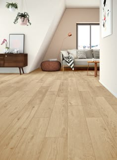 a living room with wood flooring and white walls in an attic style home setting