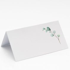 a white card with green leaves on it