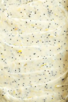 a casserole dish with white sauce and black speckles