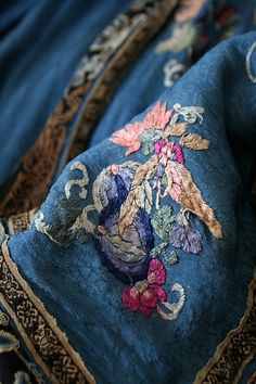 an embroidered piece of cloth with flowers on it