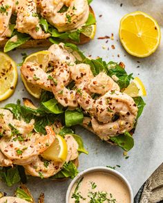 grilled shrimp on toast with lemon wedges and garnish