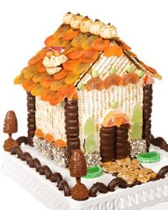 a decorative gingerbread house with nuts and candies