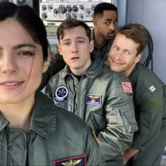 a group of men and women in pilot's uniforms posing for a photo together