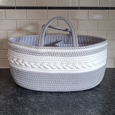 a basket sitting on top of a counter next to a tile backsplash in a kitchen