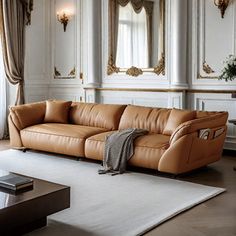 a tan leather couch sitting on top of a white rug