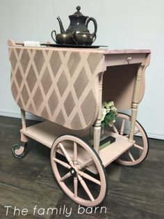 an old fashioned cart with a potted plant on top