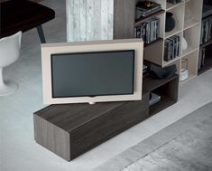 a television sitting on top of a wooden stand in front of a book shelf filled with books